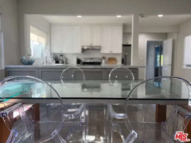 a kitchen with stainless steel appliances granite countertop a sink and a stove