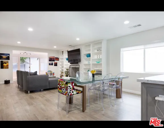a living room with furniture and kitchen view