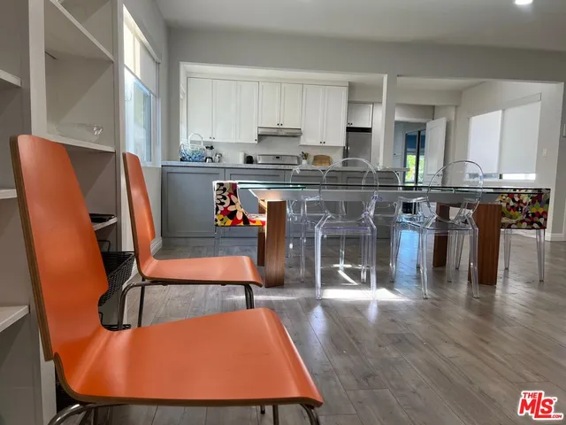a living room filled with furniture and a wooden floor