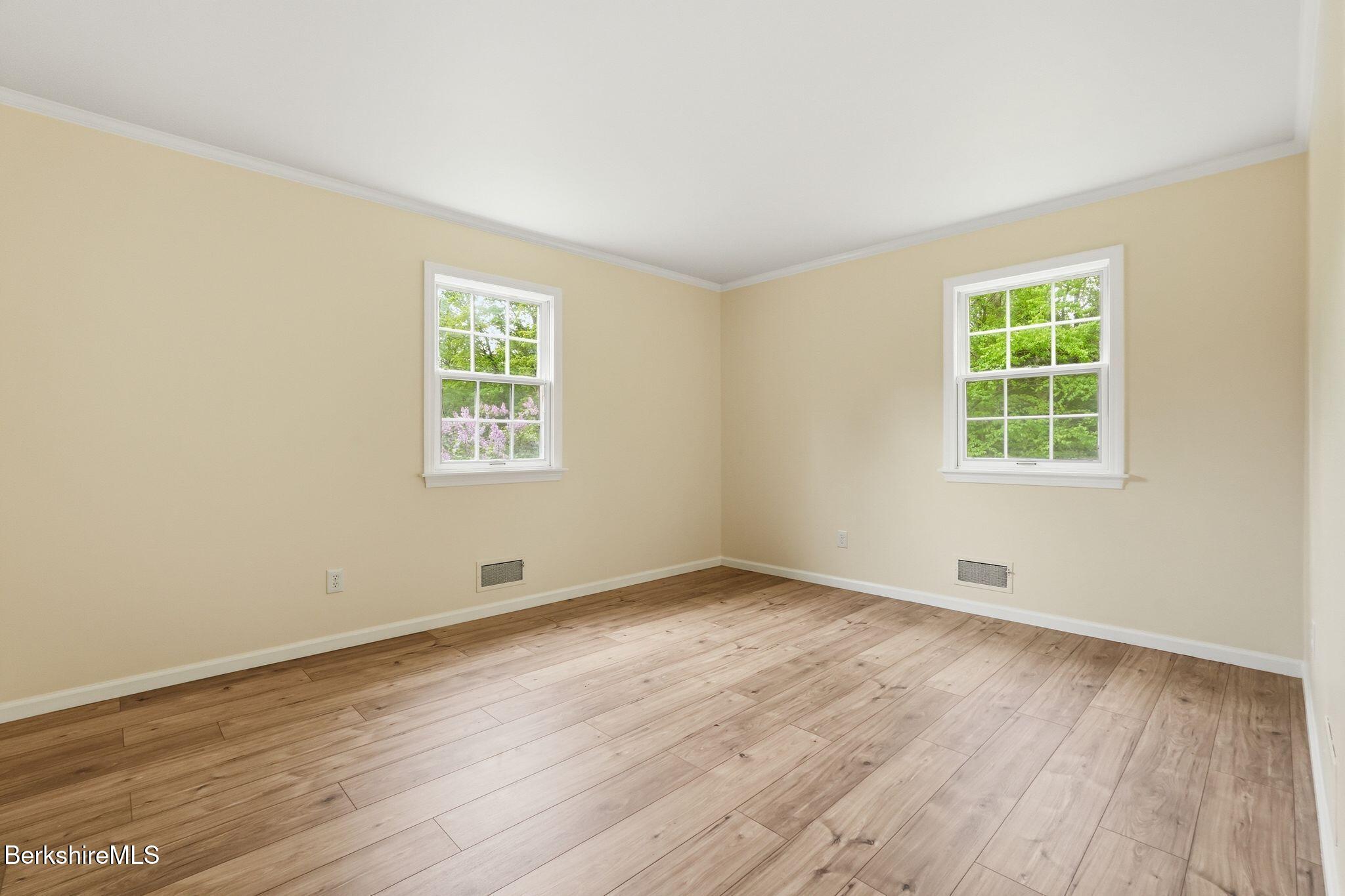 98 N Road Monroe, MA 01247 - Photo 16 of 32 an empty room with wooden floor and windows