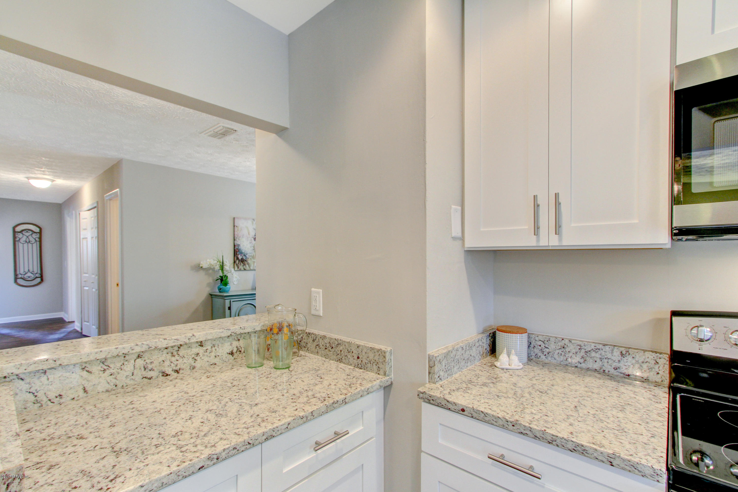 8236 Cassie Road Jacksonville, FL 32221 - Photo 13 of 29 a view of a kitchen with granite countertop white cabinets and sink