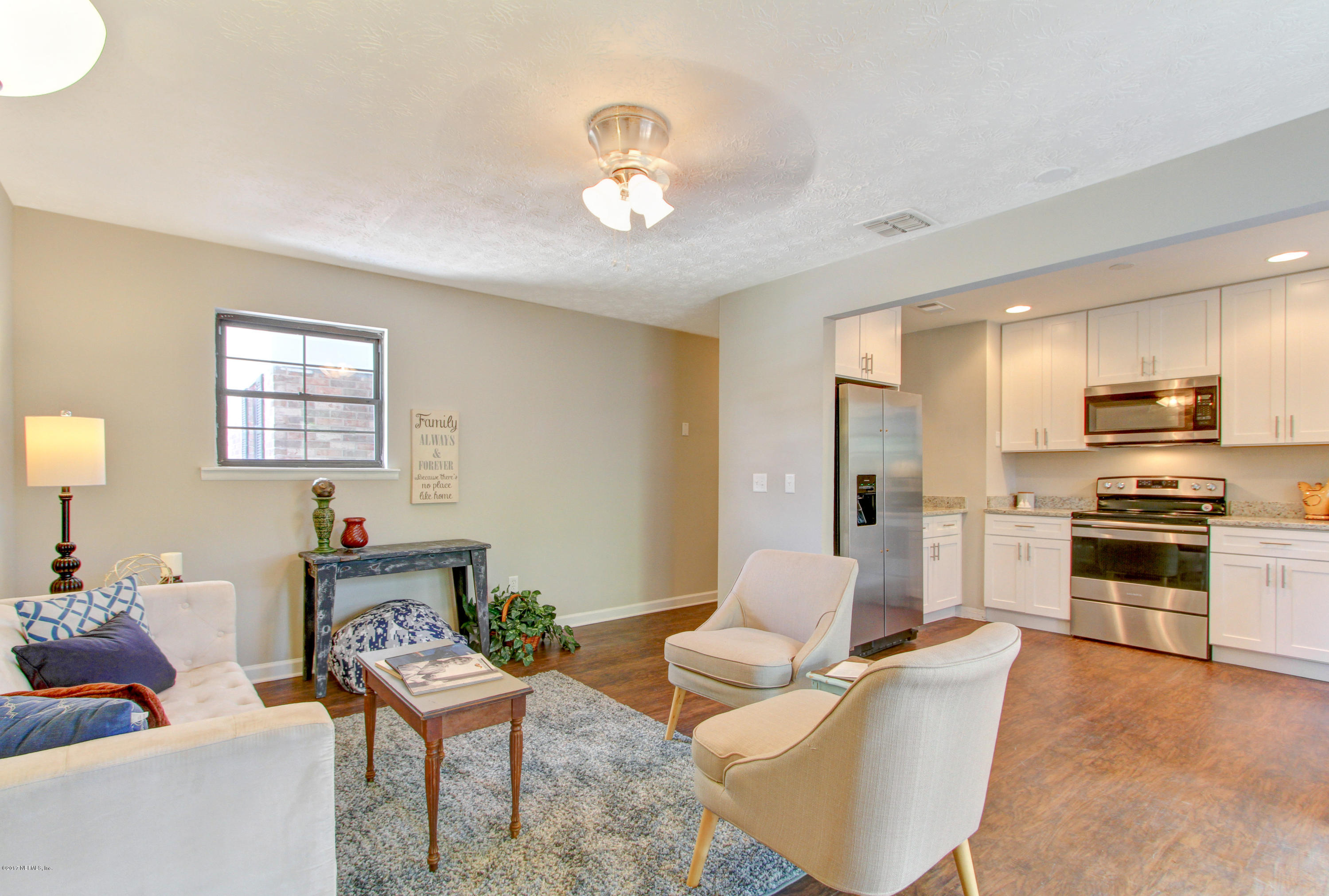 8236 Cassie Road Jacksonville, FL 32221 - Photo 14 of 29 a living room with furniture and a chandelier