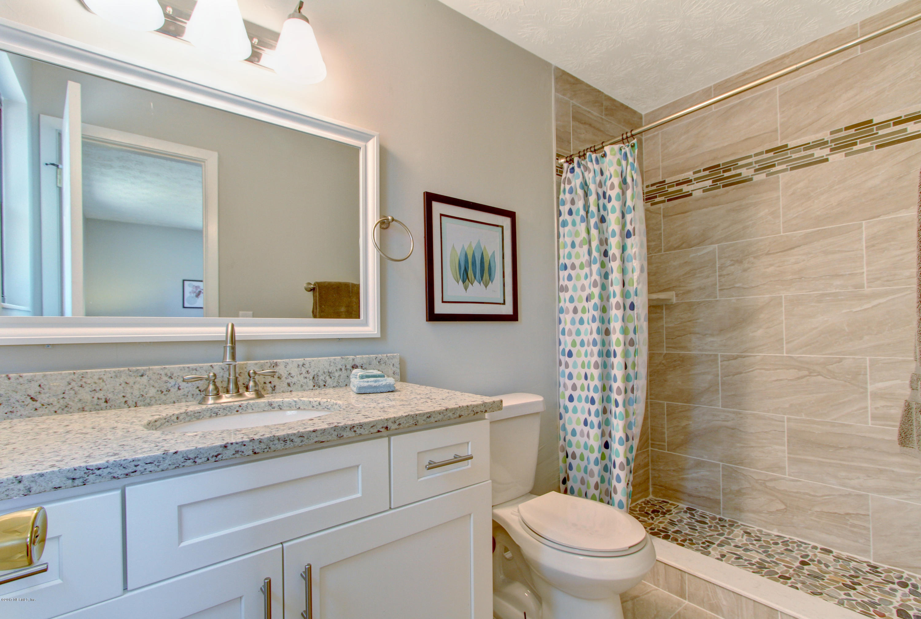 8236 Cassie Road Jacksonville, FL 32221 - Photo 15 of 29 a bathroom with a granite countertop sink a toilet and shower