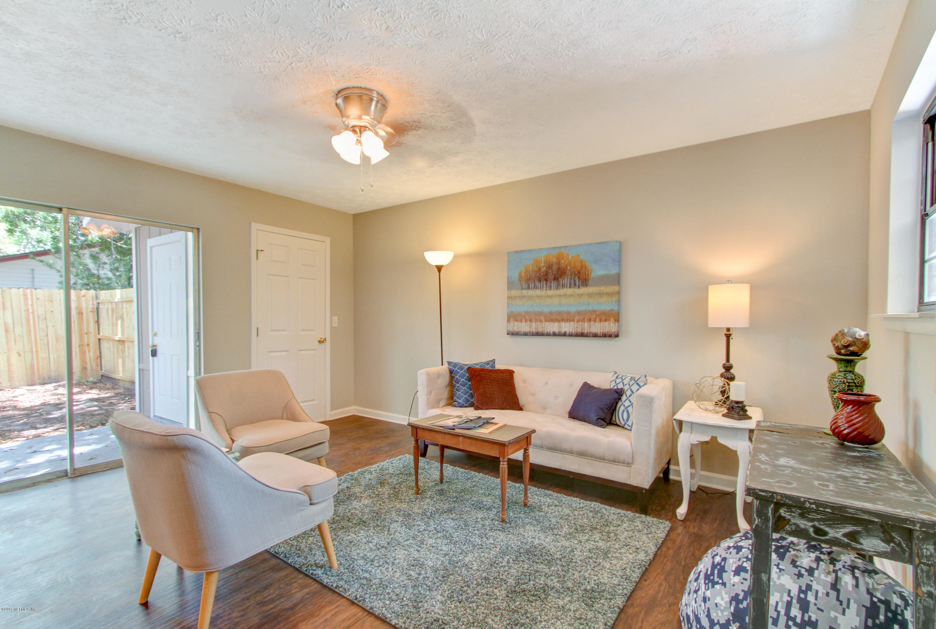 8236 Cassie Road Jacksonville, FL 32221 - Photo 16 of 29 a living room with furniture and a chandelier