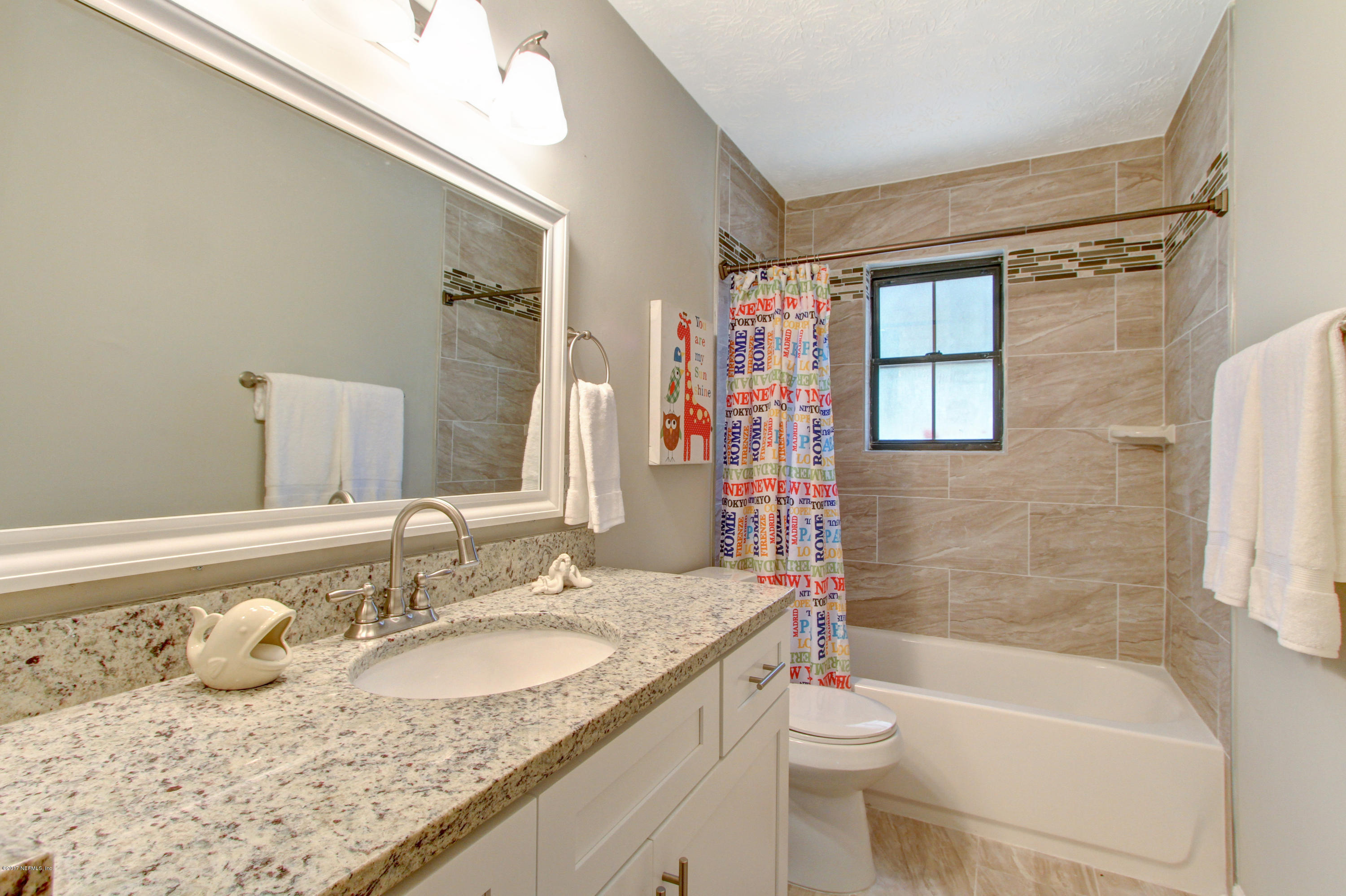 8236 Cassie Road Jacksonville, FL 32221 - Photo 19 of 29 a bathroom with a granite countertop sink toilet and shower
