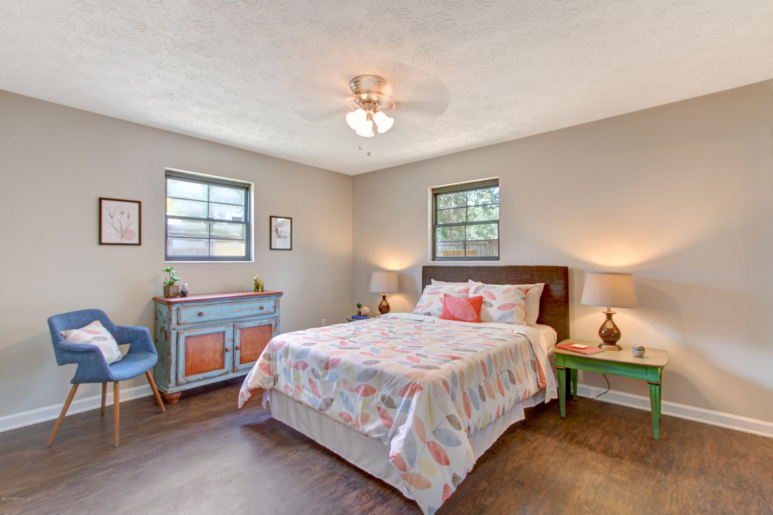 8236 Cassie Road Jacksonville, FL 32221 - Photo 20 of 29 a bedroom with a bed and a chandelier