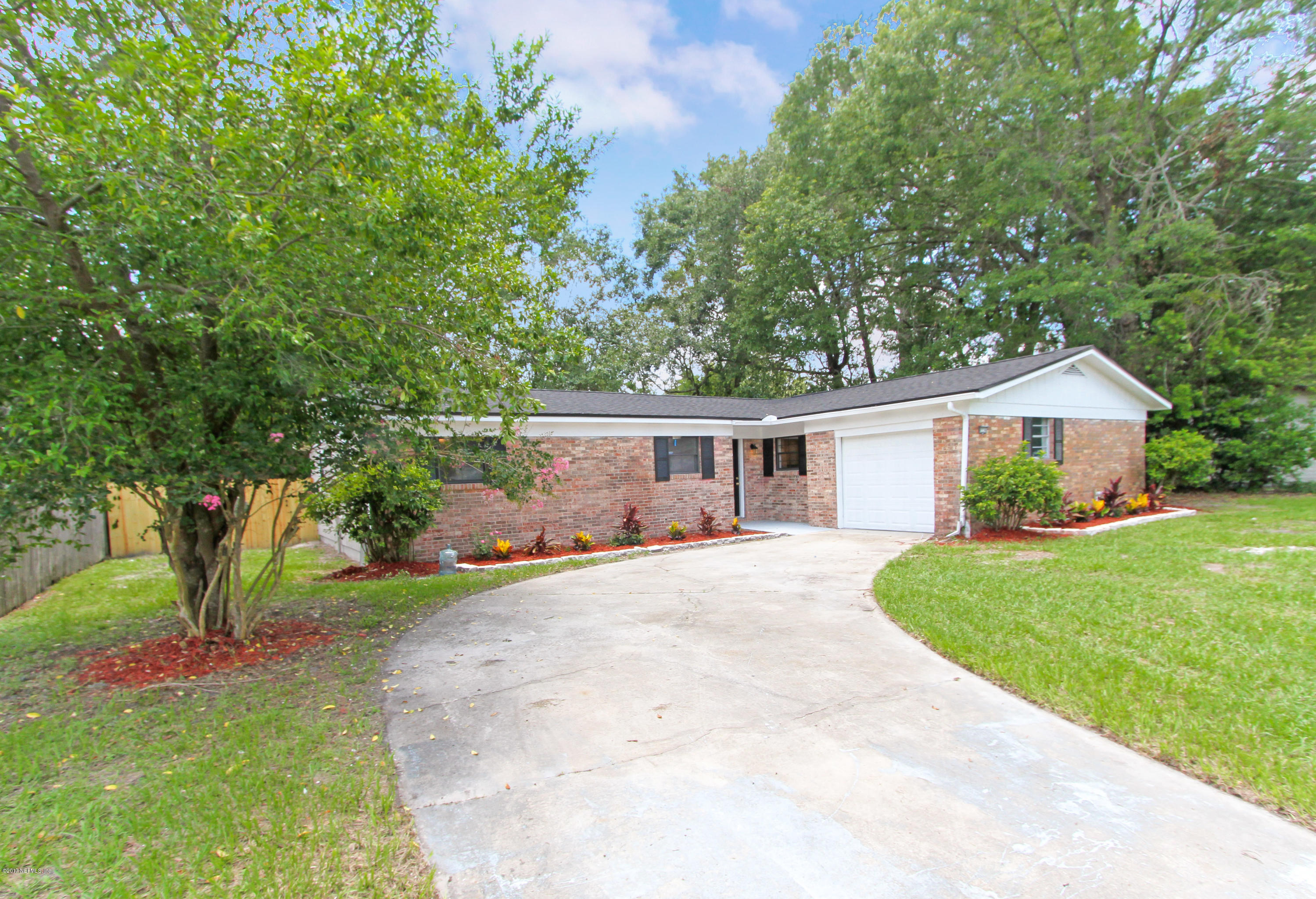 8236 Cassie Road Jacksonville, FL 32221 - Photo 2 of 29 a front view of a house with a garden and deck
