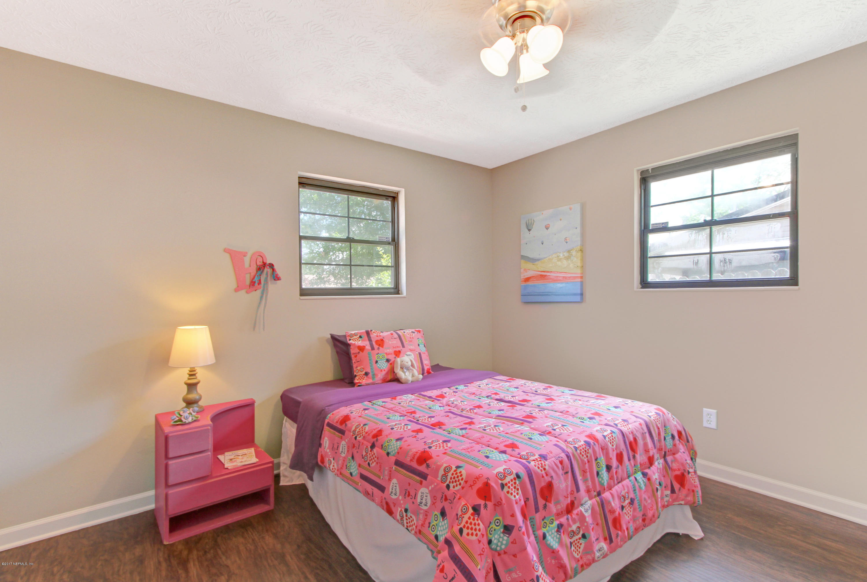 8236 Cassie Road Jacksonville, FL 32221 - Photo 22 of 29 a bedroom with a bed and a chandelier