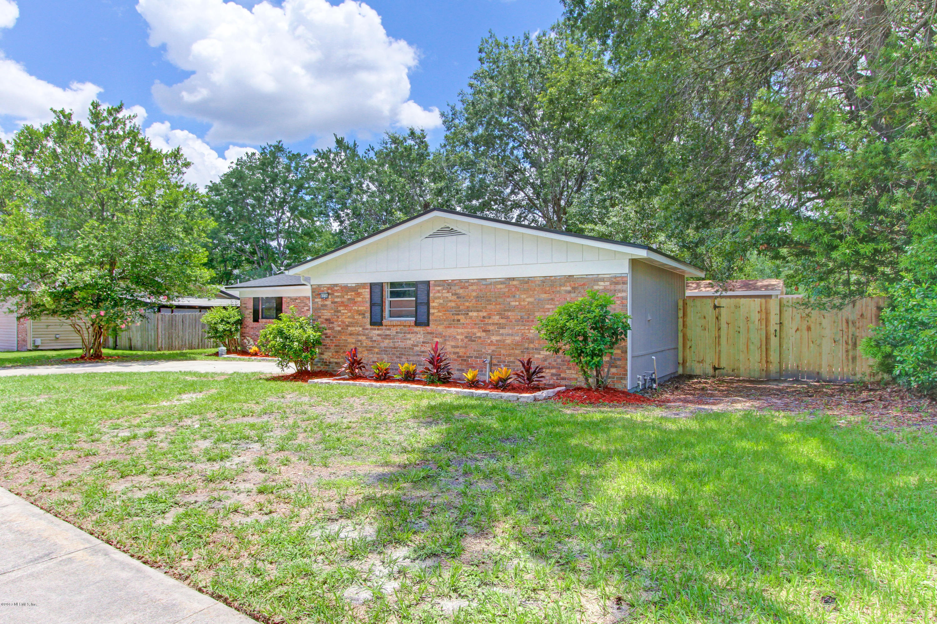 8236 Cassie Road Jacksonville, FL 32221 - Photo 3 of 29 a front view of a house with a yard and garage