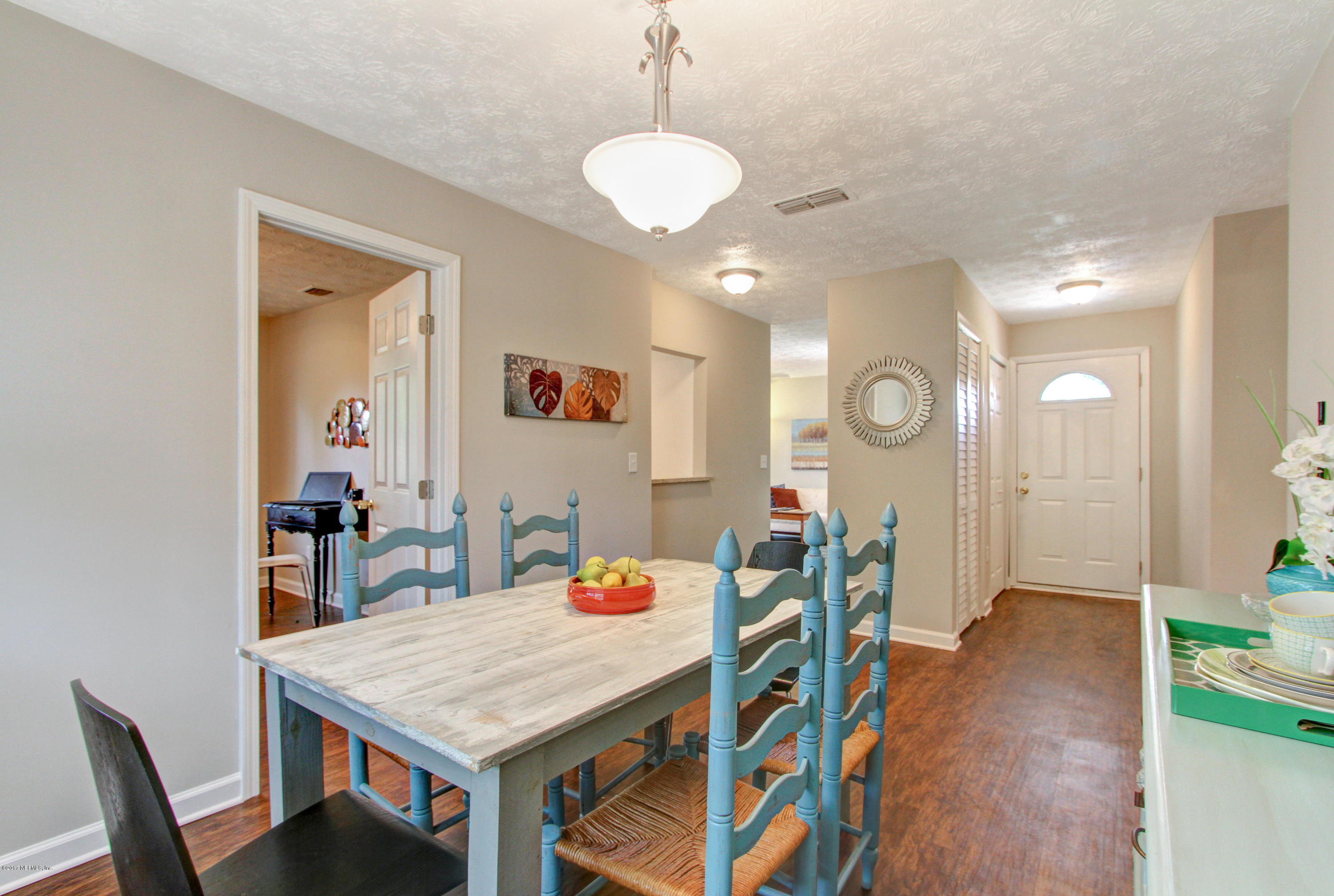8236 Cassie Road Jacksonville, FL 32221 - Photo 6 of 29 a view of a dining room with furniture and wooden floor