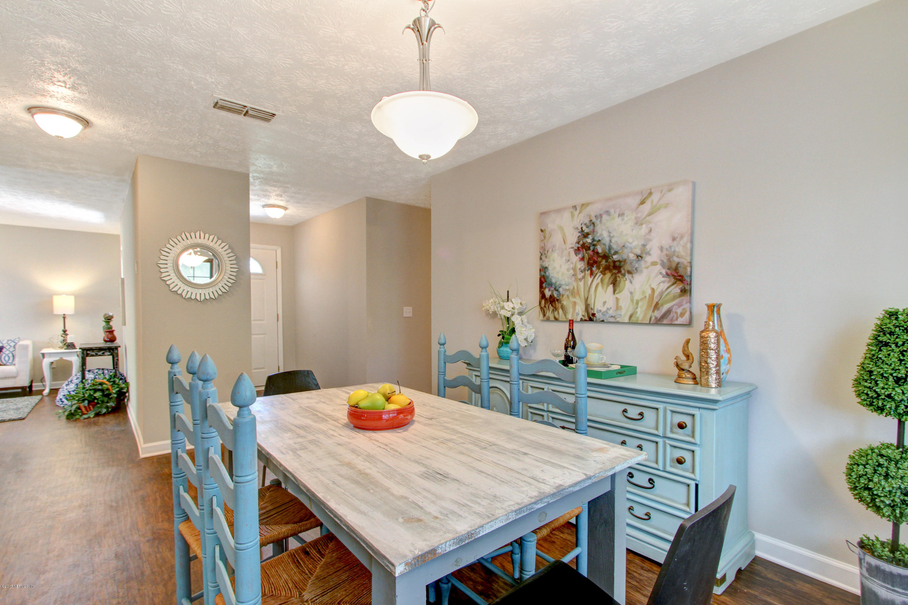 8236 Cassie Road Jacksonville, FL 32221 - Photo 8 of 29 a view of a dining room with furniture and wooden floor