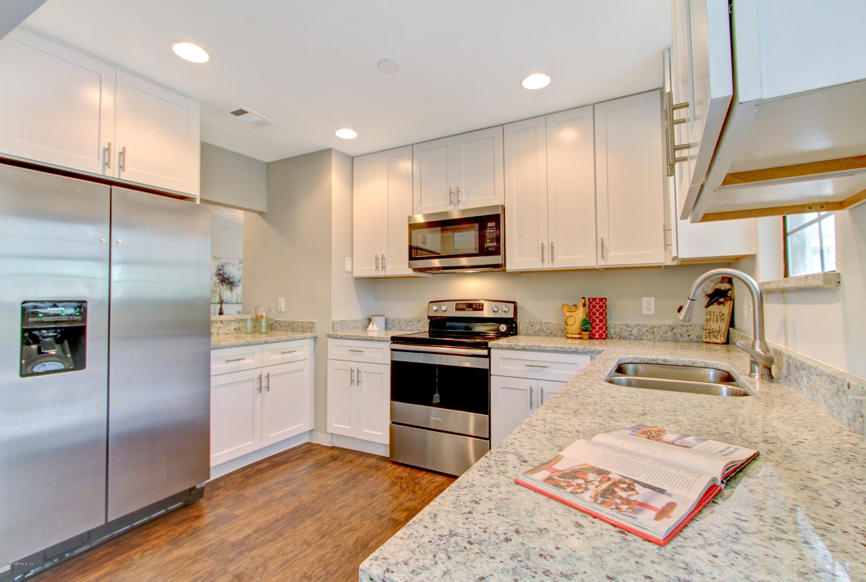 8236 Cassie Road Jacksonville, FL 32221 - Photo 10 of 29 a kitchen with stainless steel appliances granite countertop a refrigerator sink and microwave