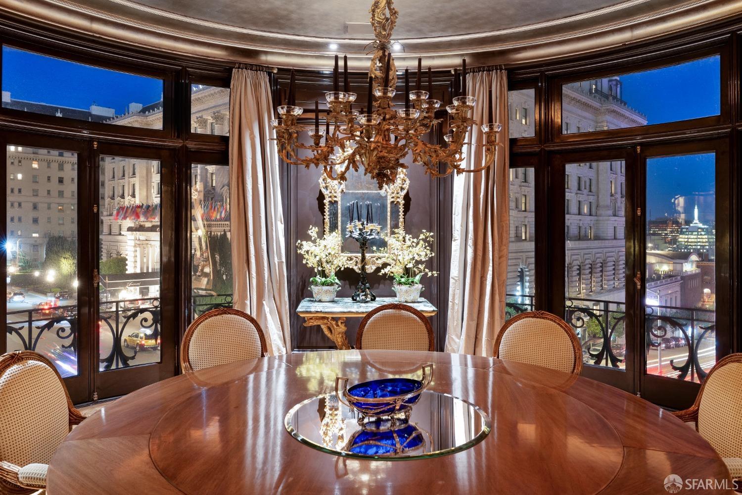 a view of a dining room with furniture chandelier and glass windows