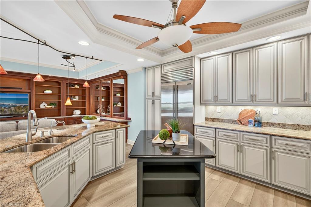 285 Grande Way, Unit 804 Naples, FL 34110 - Photo 13 of 50 a kitchen with a sink window and cabinets