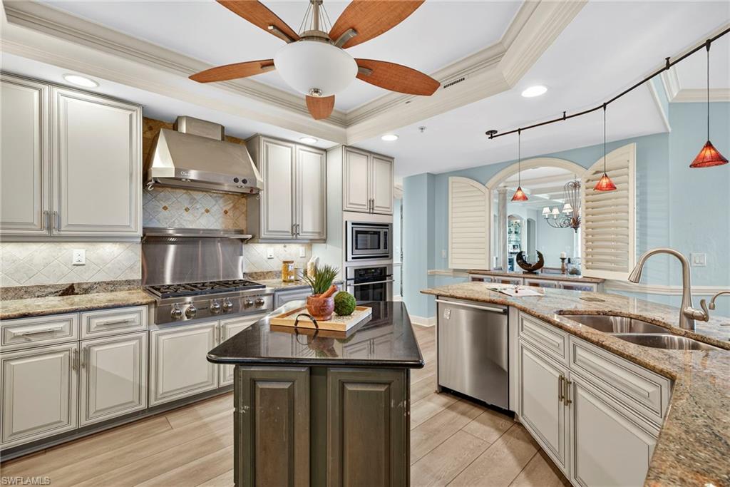 285 Grande Way, Unit 804 Naples, FL 34110 - Photo 14 of 50 a kitchen with stainless steel appliances a sink stove and refrigerator
