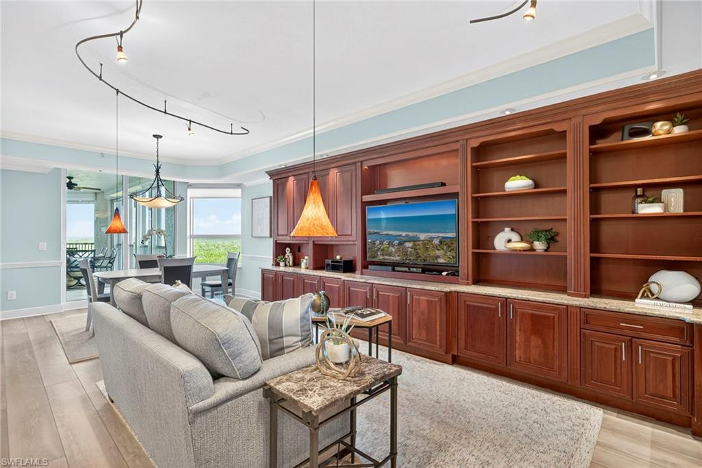 285 Grande Way, Unit 804 Naples, FL 34110 - Photo 19 of 50 a living room with furniture a rug and a flat screen tv