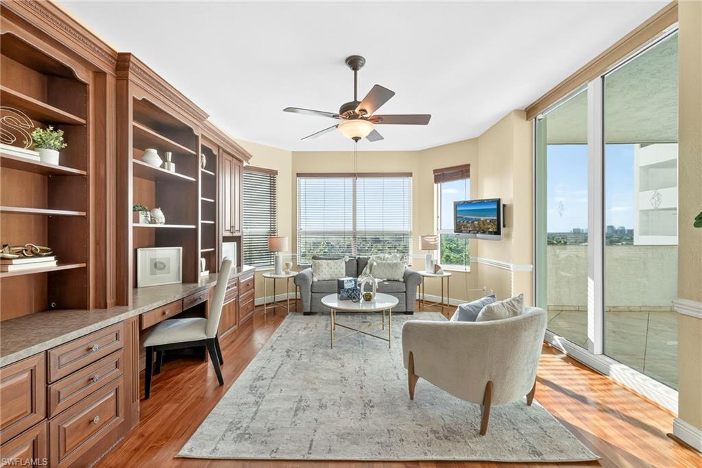 285 Grande Way, Unit 804 Naples, FL 34110 - Photo 24 of 50 a living room with furniture and a floor to ceiling window