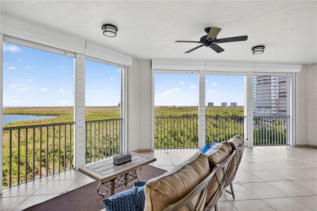 285 Grande Way, Unit 804 Naples, FL 34110 - Photo 35 of 50 a living room with furniture and a floor to ceiling window
