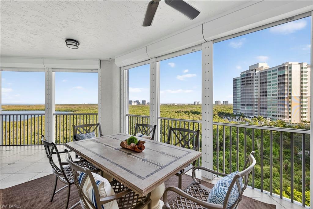 285 Grande Way, Unit 804 Naples, FL 34110 - Photo 38 of 50 a view of a city from a dining room with a table and chairs