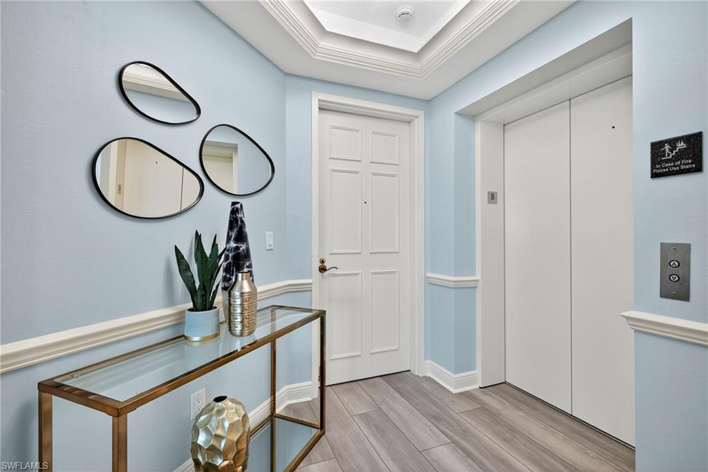 285 Grande Way, Unit 804 Naples, FL 34110 - Photo 4 of 50 a view of a hallway with wooden floor