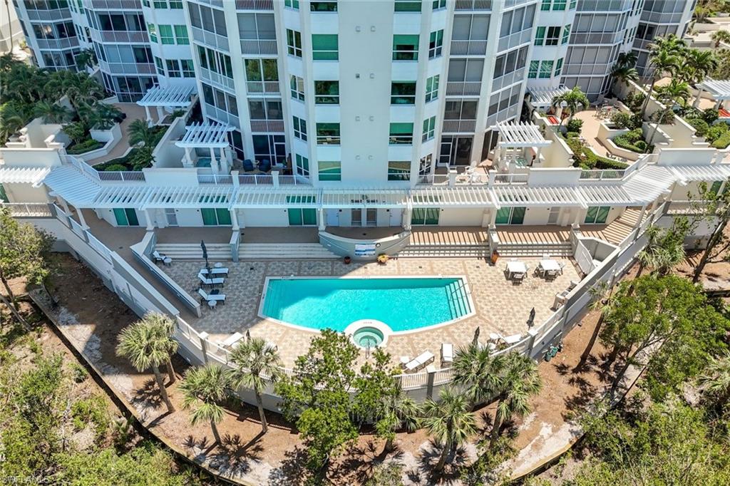 285 Grande Way, Unit 804 Naples, FL 34110 - Photo 49 of 50 a view of a swimming pool with outdoor seating and plants