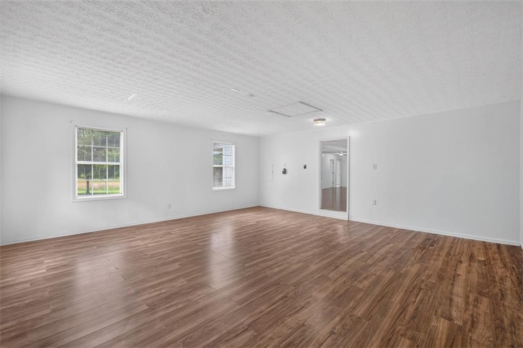 602 Pendergrass Road Winder, GA 30680 - Photo 35 of 44 a view of an empty room with wooden floor and a window