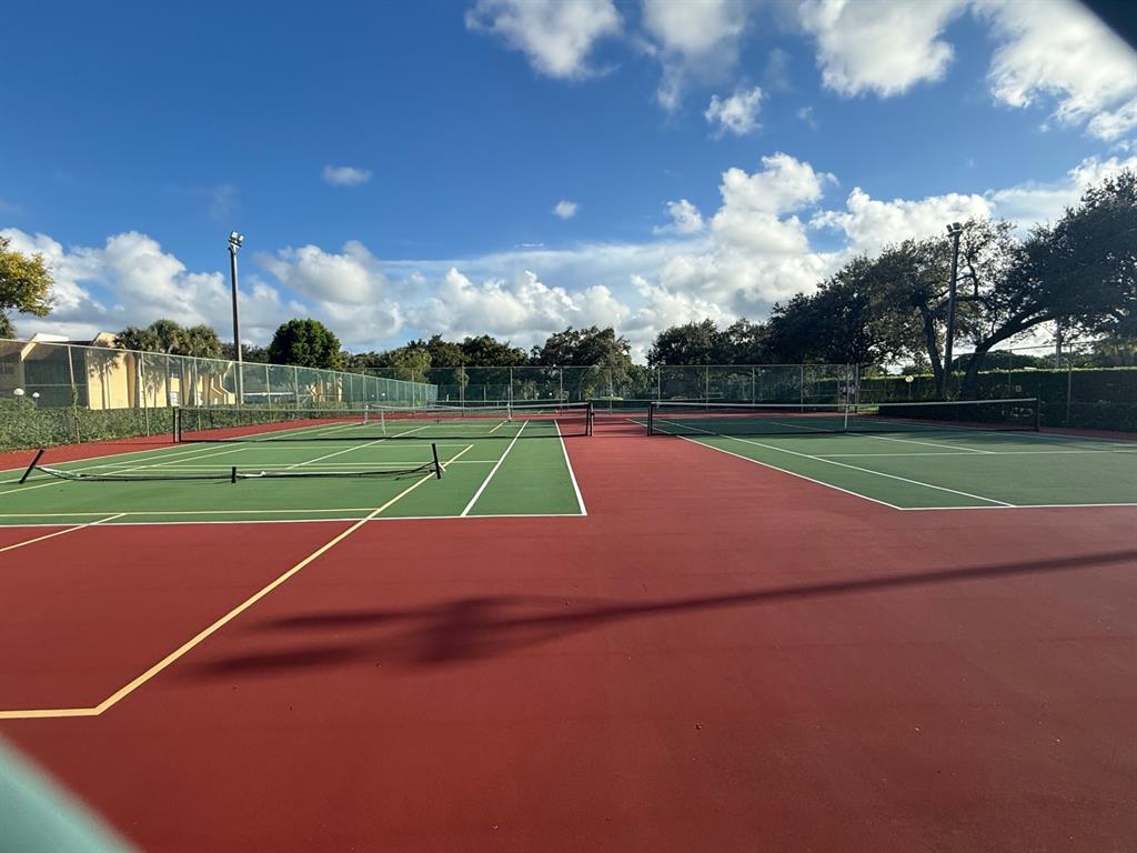 2925 Southwest 22nd Avenue, Unit 2020 Delray Beach, FL 33445 - Photo 4 of 4 a view of an outdoor space and tennis court