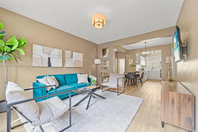 a living room with furniture and a potted plant