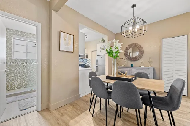 a view of a dining room with furniture and a chandelier