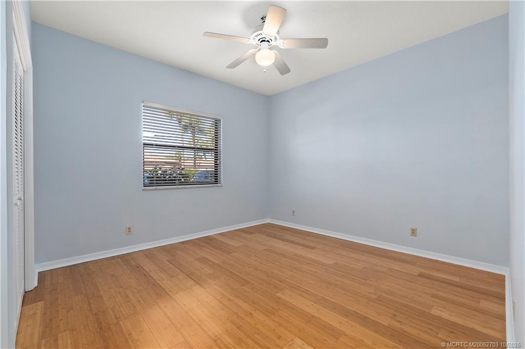 6122 Southeast Landing Way, Unit 4 Stuart, FL 34997 - Photo 13 of 29 wooden floor in an empty room with a window