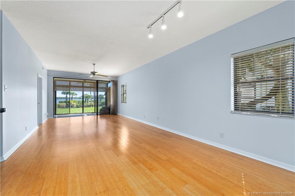 6122 Southeast Landing Way, Unit 4 Stuart, FL 34997 - Photo 15 of 29 a view of empty room with wooden floor and fan