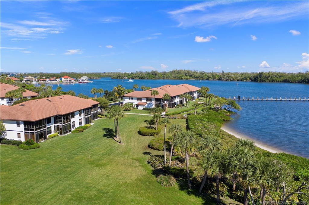 6122 Southeast Landing Way, Unit 4 Stuart, FL 34997 - Photo 24 of 29 an aerial view of a house with a garden and houses