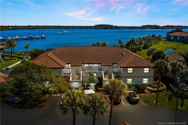 an aerial view of a house with outdoor space and lake view