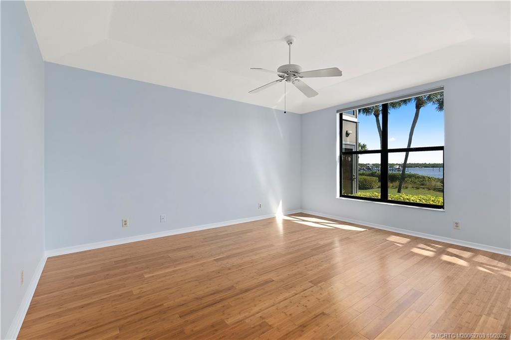 6122 Southeast Landing Way, Unit 4 Stuart, FL 34997 - Photo 3 of 29 wooden floor in an empty room with a window