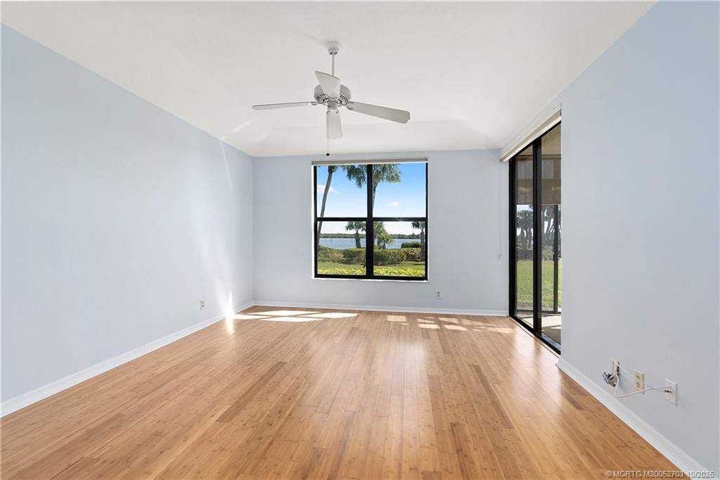 6122 Southeast Landing Way, Unit 4 Stuart, FL 34997 - Photo 4 of 29 wooden floor in an empty room with a window