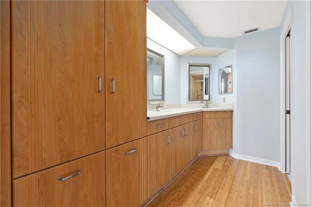 6122 Southeast Landing Way, Unit 4 Stuart, FL 34997 - Photo 6 of 29 a bathroom with a sink and mirror