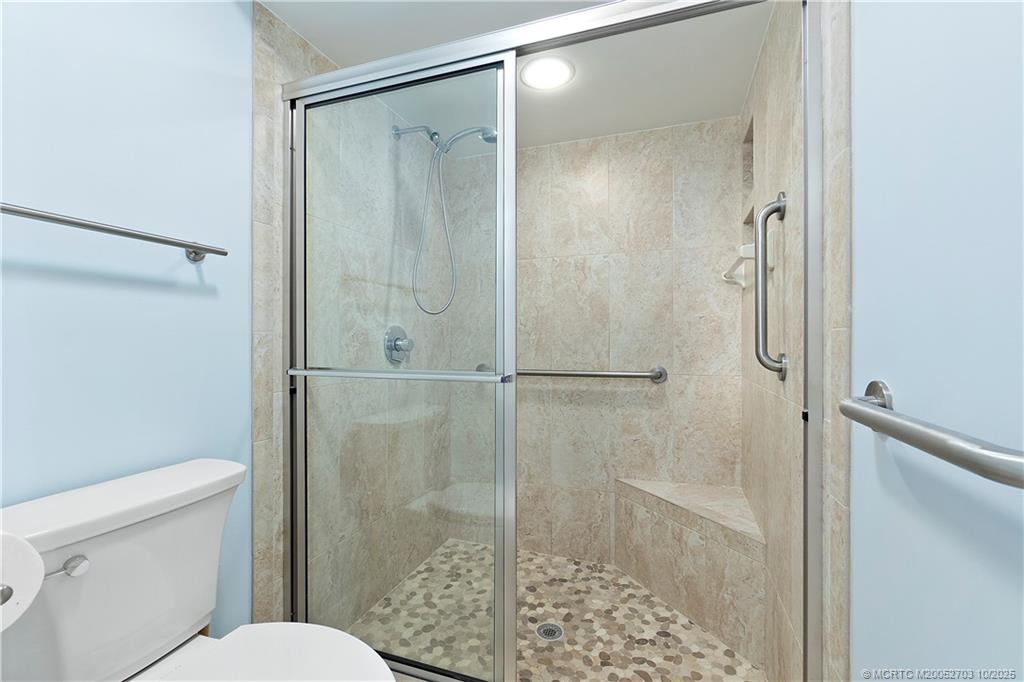 6122 Southeast Landing Way, Unit 4 Stuart, FL 34997 - Photo 7 of 29 a bathroom with a shower a toilet and a sink