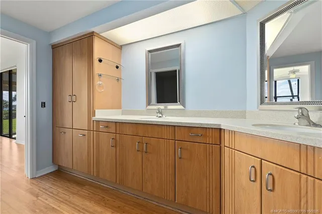 a bathroom with a double vanity sink and mirror