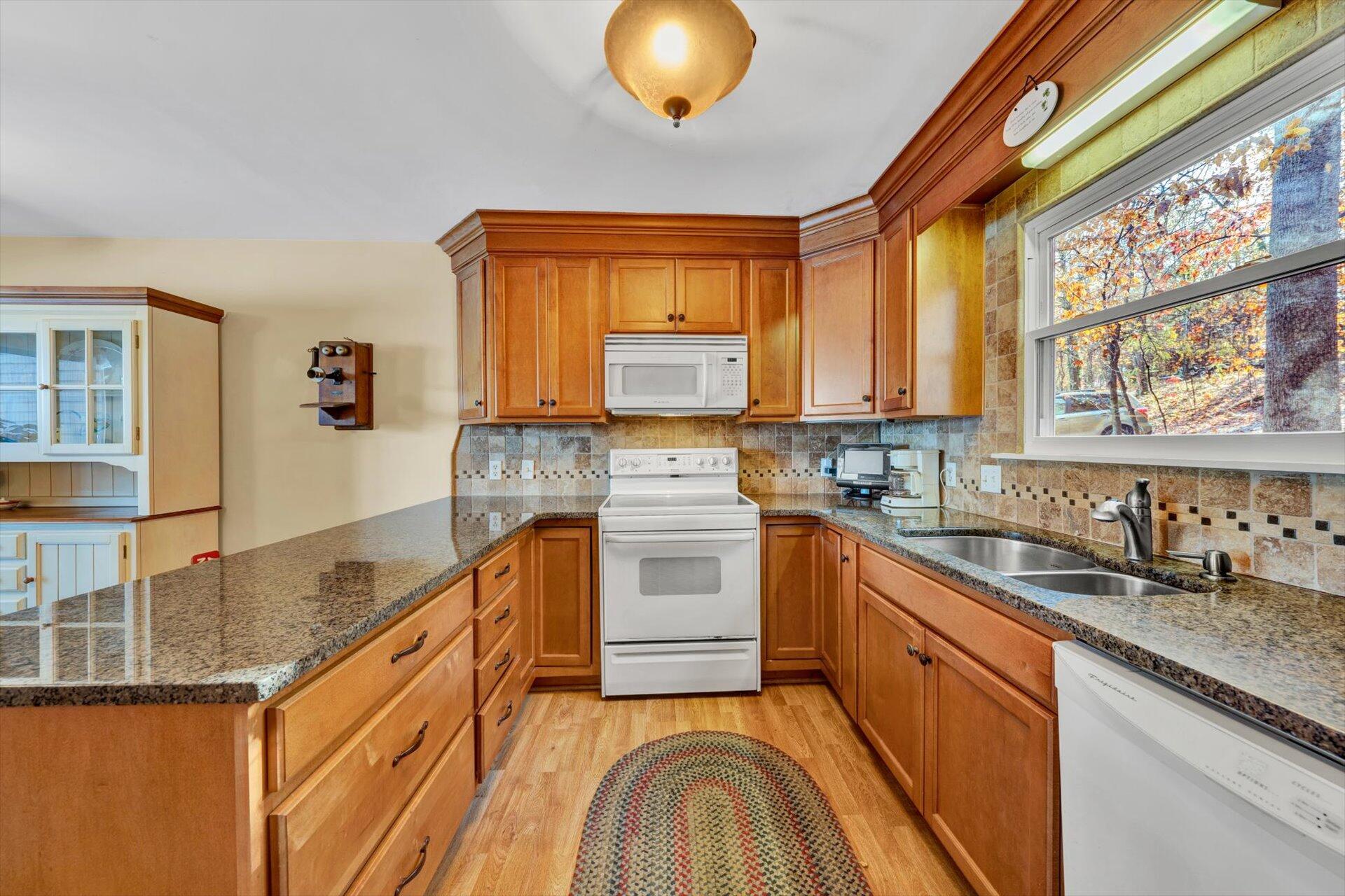 505 Highland Lake Road Union Hall, VA 24176 - Photo 26 of 58 a kitchen with stainless steel appliances granite countertop a stove a sink and a microwave