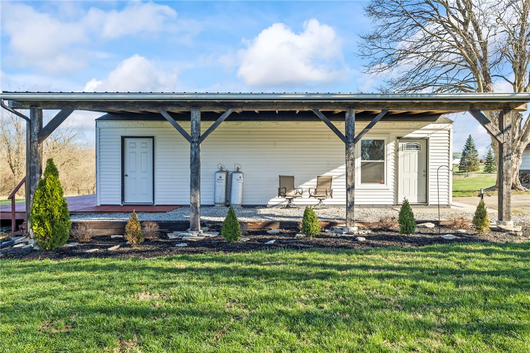 10797 Gratis Jacksonburg Road Somerville, OH 45064 - Photo 5 of 27 This charming structure features a covered porch, offering a perfect spot to enjoy the expansive yard.