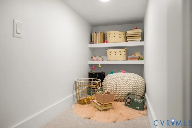 an empty room with wooden floor closet and windows
