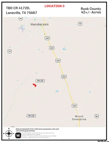 a view of a dry yard with trees