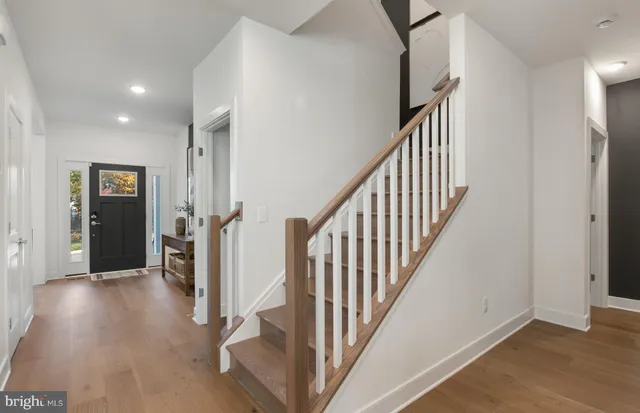 a view of an entryway with wooden floor and stairs