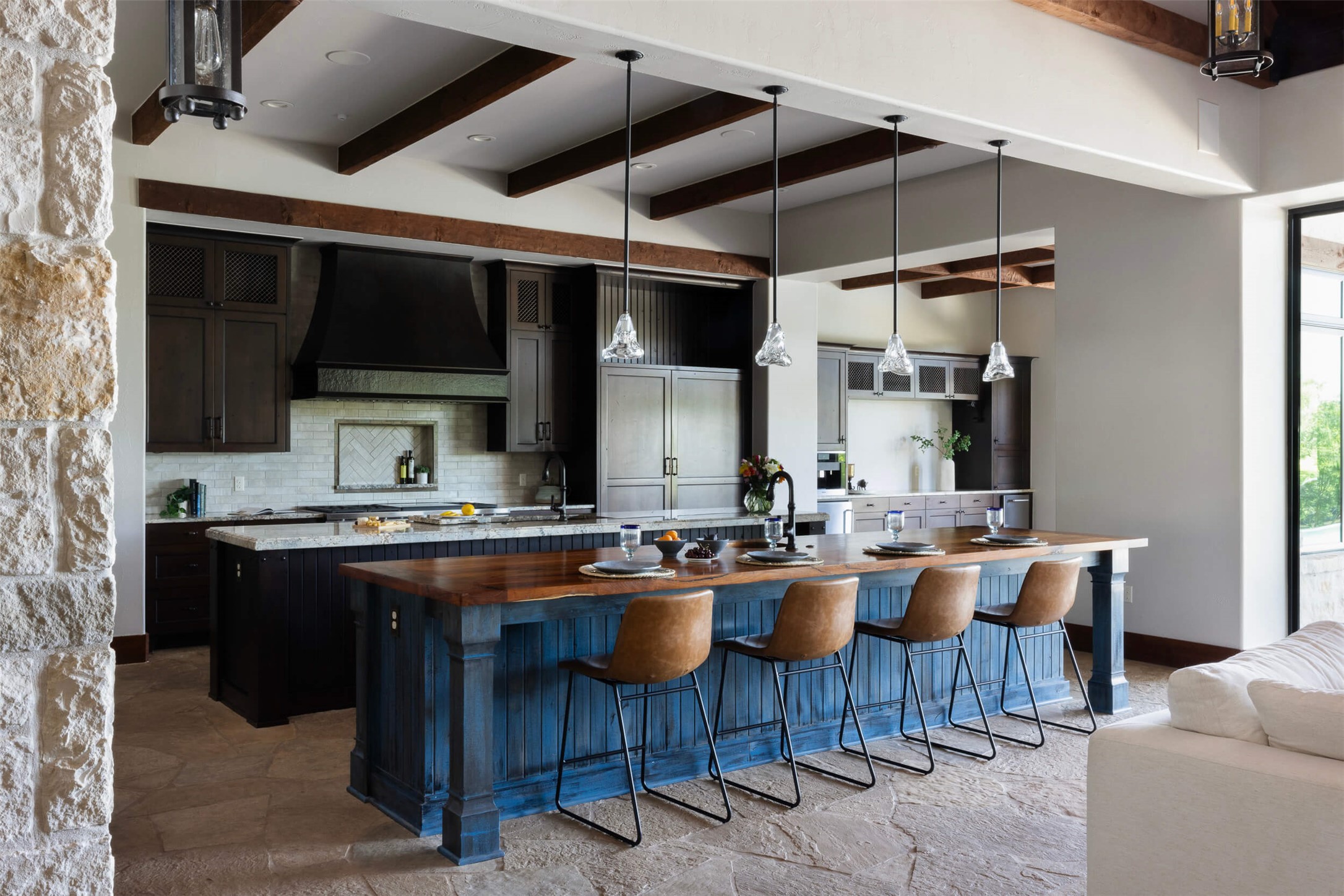 15016 Flat Top Ranch Road Austin, TX 78732 - Photo 21 of 40 Kitchen with pendant lighting, beam ceiling, a kitchen breakfast bar, decorative backsplash, and ventilation hood