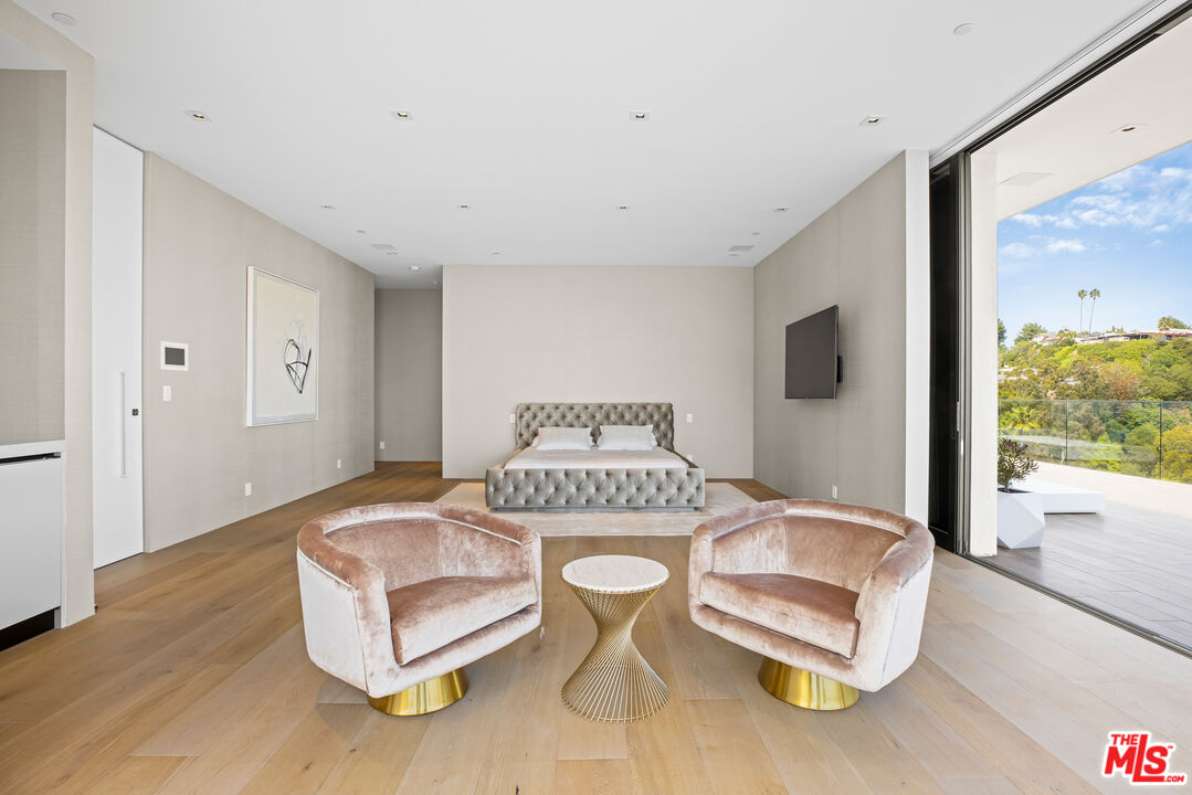 9674 Highridge Drive Beverly Hills, CA 90210 - Photo 11 of 29 a living room with furniture and a large window