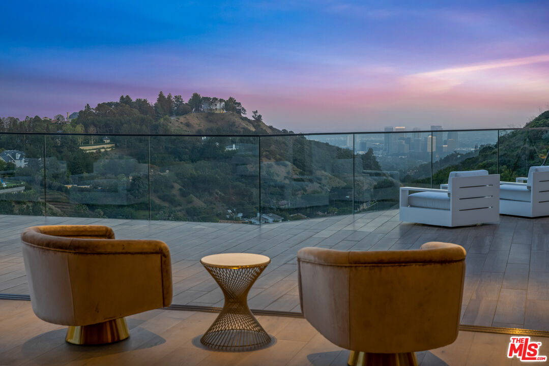 9674 Highridge Drive Beverly Hills, CA 90210 - Photo 17 of 29 a view of a chairs and table in the terrace