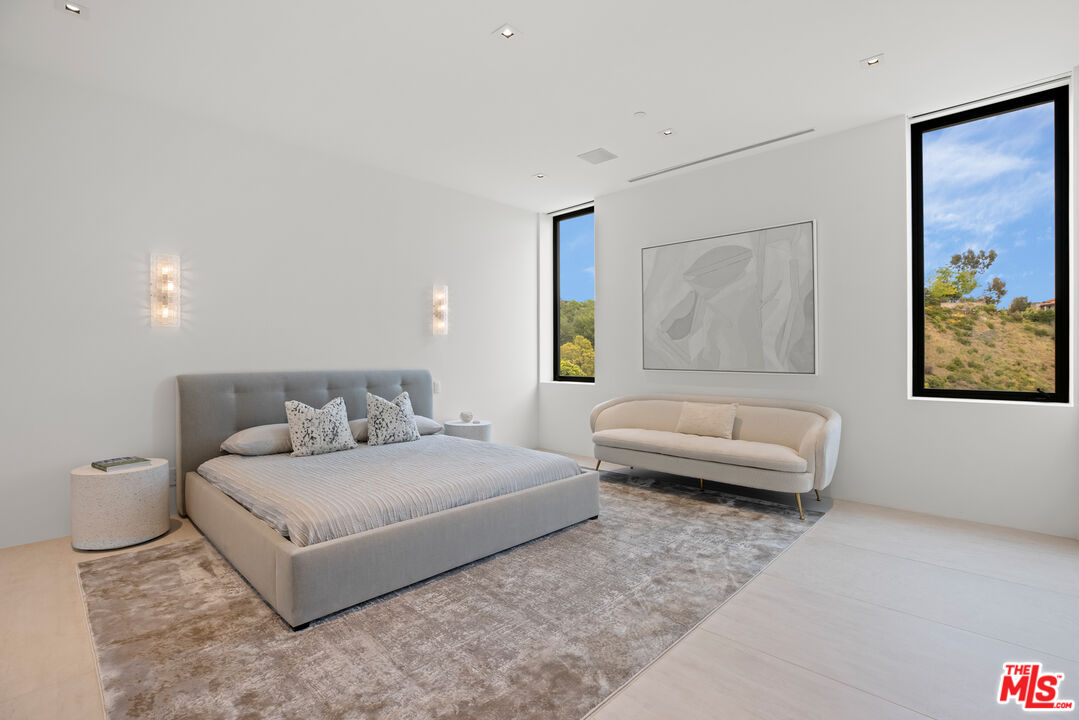 9674 Highridge Drive Beverly Hills, CA 90210 - Photo 19 of 29 a bedroom with a bed and a couch