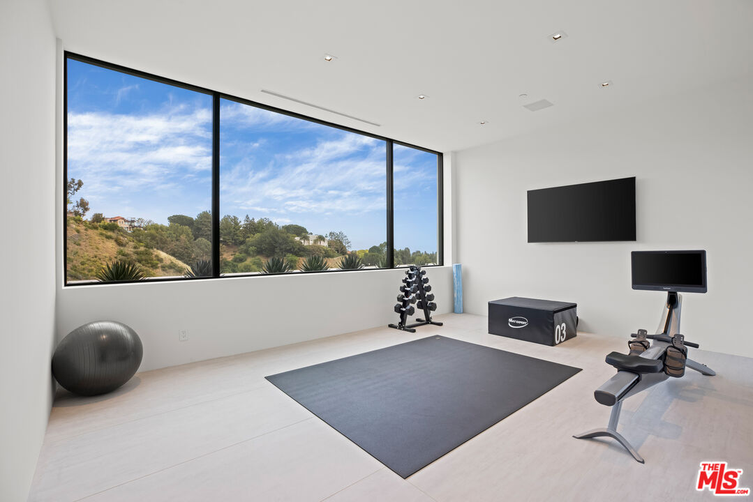 9674 Highridge Drive Beverly Hills, CA 90210 - Photo 22 of 29 a living room with furniture and a flat screen tv