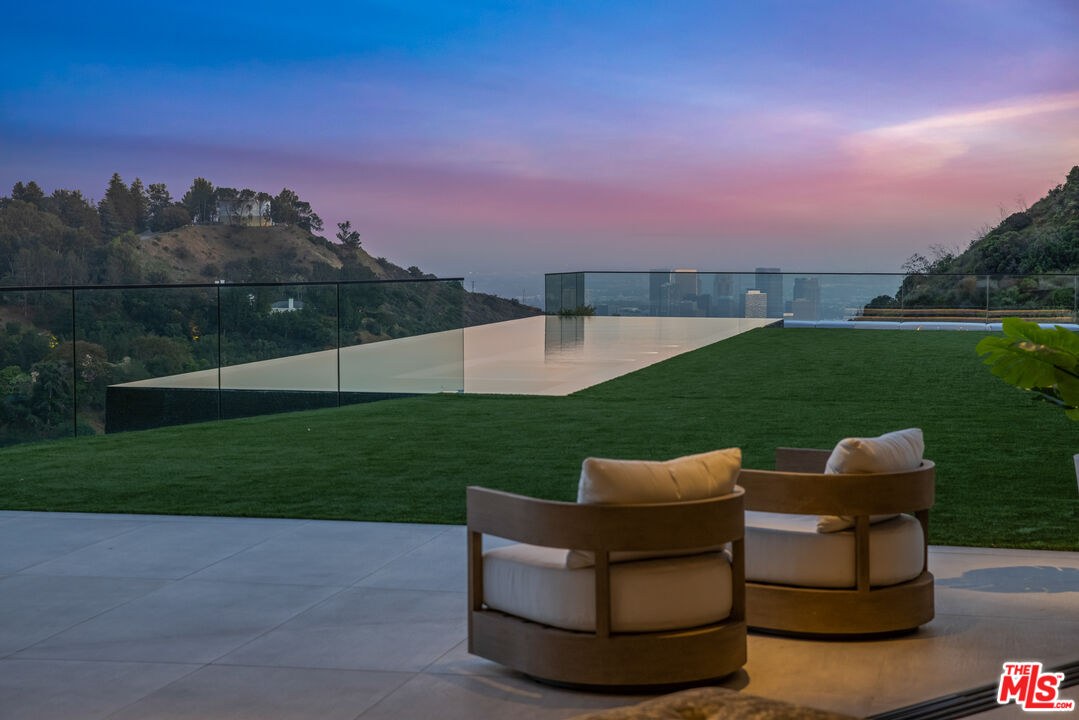 9674 Highridge Drive Beverly Hills, CA 90210 - Photo 23 of 29 a view of a garden with chairs