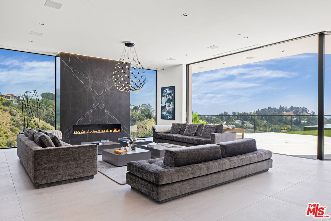 9674 Highridge Drive Beverly Hills, CA 90210 - Photo 4 of 29 a living room with furniture and a large window